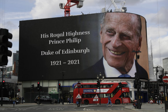 A tribute is projected onto a large screen at Piccadilly Circus in London.