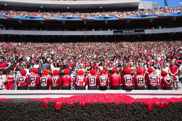 Fans observe a moment of silence for victims of Wednesday’s school shooting at Apalachee High School before an NCAA college football game between Tennessee Tech and Georgia on Saturday.