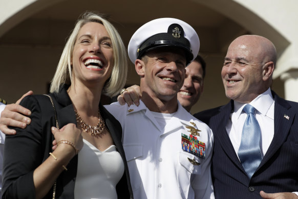 Chief Petty Officer Edward Gallagher, centre, with his wife Andrea and wearing his Trident pin as they leave a military court on Naval Base San Diego after his acquittal on all but one charge in July.