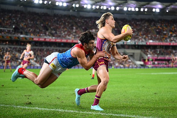 Christian Petracca shows his desperation with a lunging tackle on Brisbane’s Will Ashcroft.