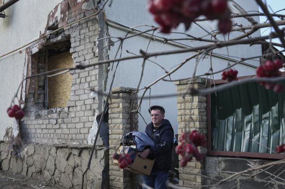 A man leaves his house after it was damaged by artillery shelling in Novoluhanske in eastern Ukraine on Wednesday. 