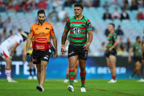 Latrell Mitchell comes from the field with Souths trainer Eddie Farah.