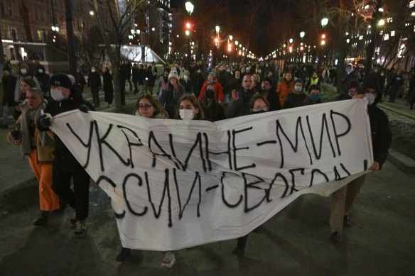 Demonstrators march with a banner that reads: “Ukraine - Peace, Russia - Freedom”, in Moscow, Russia.
