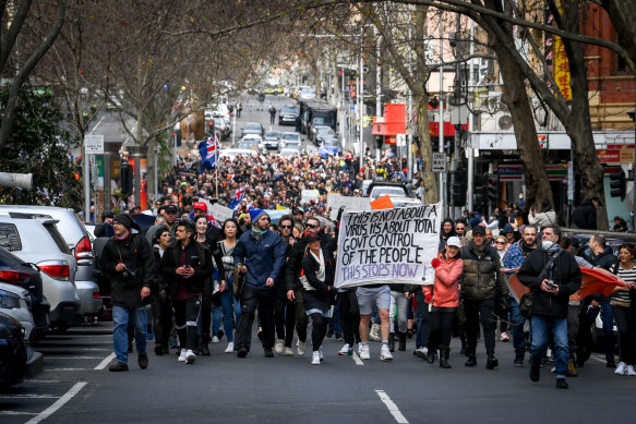 Anti-lockdown protesters march through Melbourne’s CBD on Saturday.