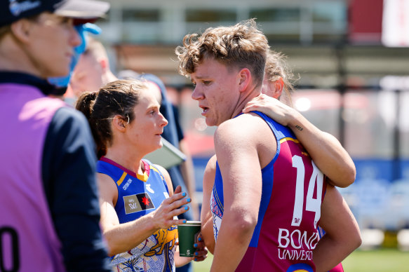 Dakota Davidson is consoled by teammates at three-quarter time during Sunday’s game against St Kilda.