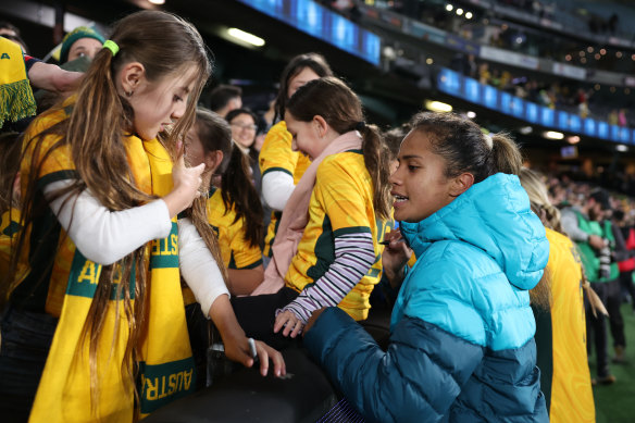 Mary Fowler signs an autograph after Friday night’s win over France.