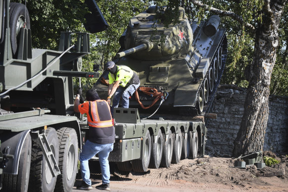 Workers removing a Soviet T-34 tank installed as a monument in Narva, Estonia, in August 2022.