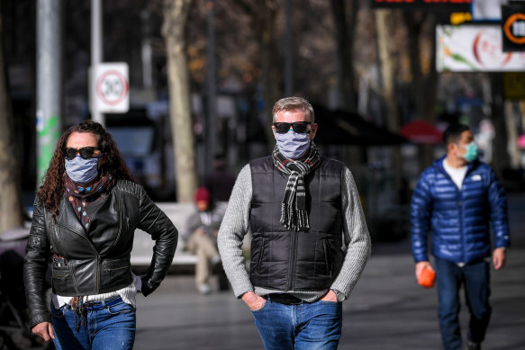 People in Melbourne CBD wearing face masks on Wednesday, a day before they became mandatory.