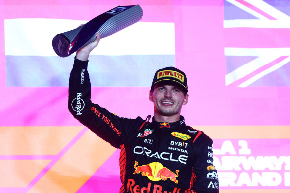 Max Verstappen celebrates on the podium after winning the F1 Grand Prix in Qatar.