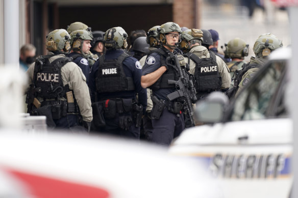 Police stand guard outside a King Soopers supermarket where a mass shooting took place.
