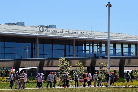 A tour group travelling on public transport arrives at Western Sydney International (Nancy-Bird Walton) Airport WSI on Thursday.