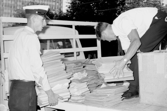 Police load a truck with files from the Scientology offices.