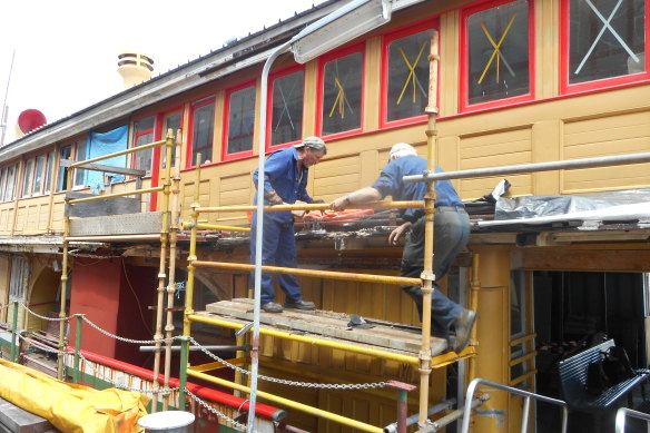 Volunteers work on the historic ferry John Oxley. 