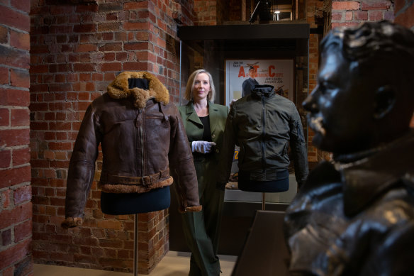 Then and now ... curator Kate Spinks-Colas with a 1940s-era bomber jacket (left), and one from today’s fashion.