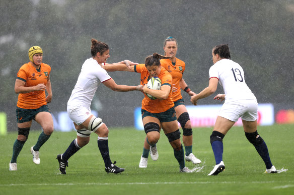 Grace Hamilton on the charge in the sodden conditions.