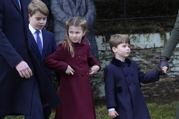 Prince George, from left, Princess Charlotte and Prince Louis leave the church after attending the Christmas day service at St Mary Magdalene Church in Sandringham.