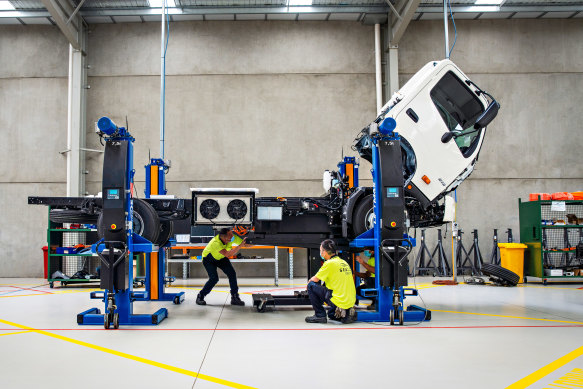 SEA Electric workers install proprietary software, drive-train and battery system on a light commercial truck.