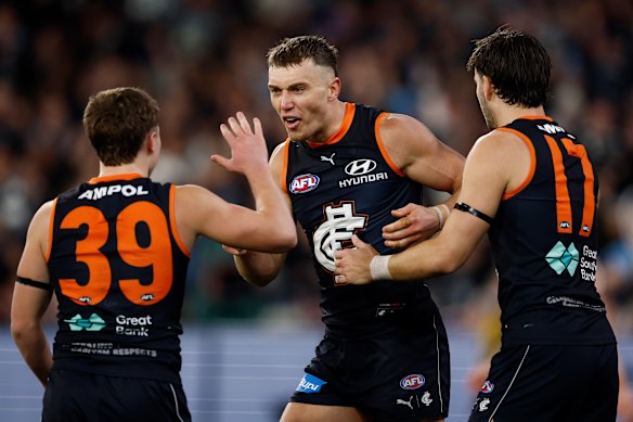 Talor Byrne, Patrick Cripps and Brodie Kemp celebrate a goal.