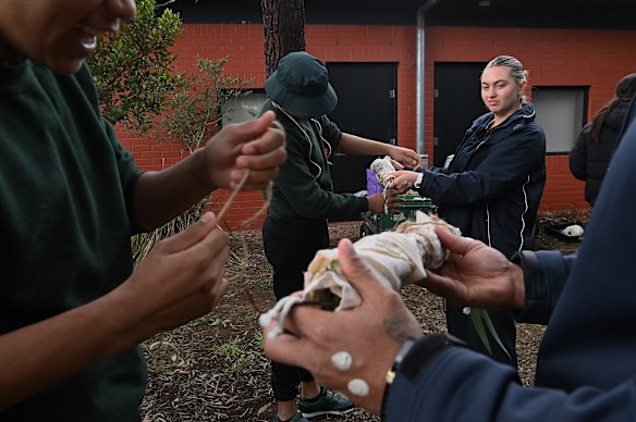 Young people learn traditional dying of material in the learning and  yarning circle area at Reiby.
