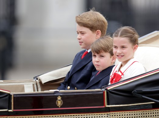 The young royals (from left) Princes George and Louis, and Princess Charlotte, wore touches of red.