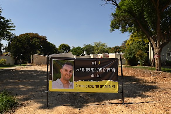 An image of Sharon Sharabi’s brother Yossi, who died in captivity, on a banner in front of where Yossi’s home once stood.