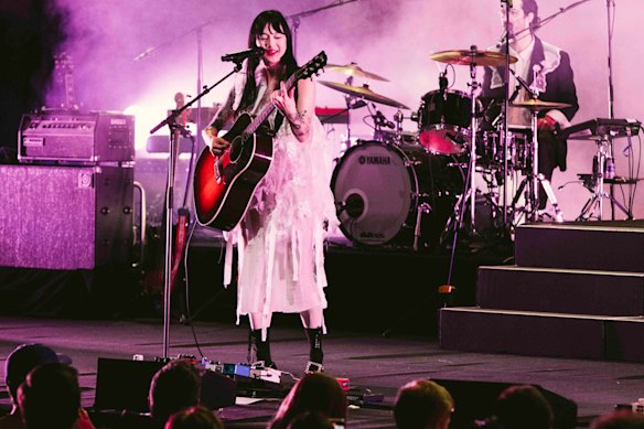 The pink glow of relief as the lights come back up for Michelle Zauner of Japanese Breakfast during Vivid Live at the Concert Hall, Sydney Opera House.
