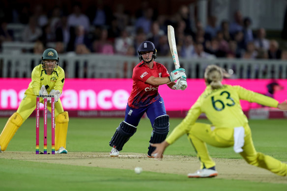 Australian bowler Ash Gardner tries to stop a drive from Alice Capsey.