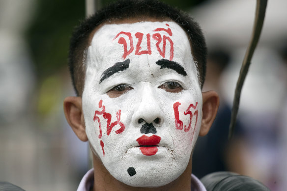 A pro-democracy demonstrator wears face paint that reads "End it with our generation" during a protest at Thammasat University in Pathum Thani, north of Bangkok.