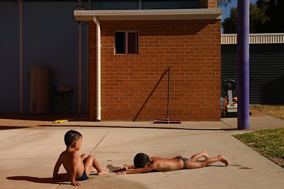 In the historic gold mining town of Peak Hill, Kingston Hill, 2, and Kruize Riley, 3, dry off as temperatures hover in the mid-30s. 