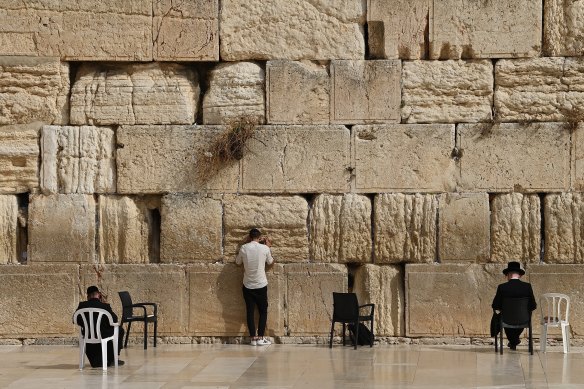 Unusually quiet: Jewish worshippers at the Western Wall in Jerusalem.