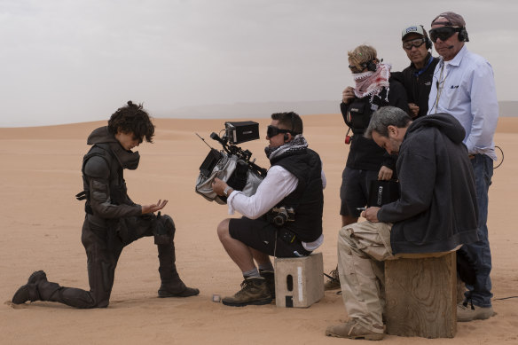 Cinematographer Greig Fraser (with camera) films a scene with Timothy Chalamet (left) on the set of Dune. The release of the sequel has been shifted to March next year.