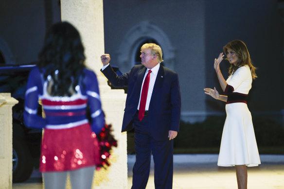 US President Donald Trump and first lady Melania Trump watch as the Florida Atlantic University Marching Band performs during a Super Bowl party at the Trump International Golf Club in West Palm Beach. 