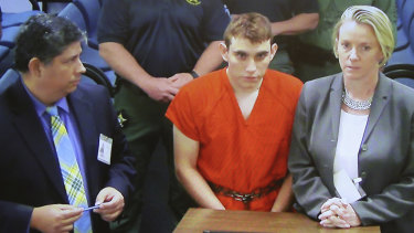 A video monitor shows school shooting suspect Nikolas Cruz in a brief court appearance on Thursday.