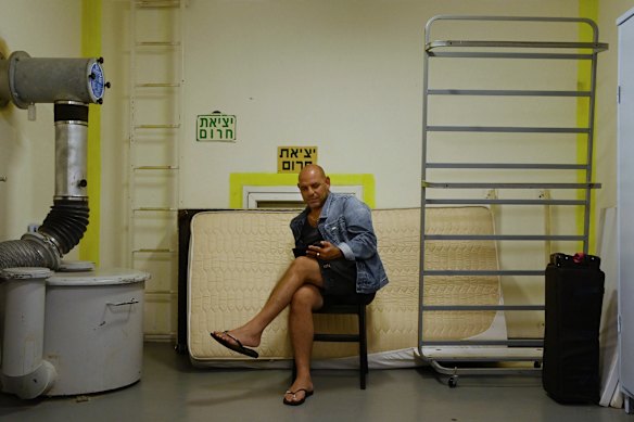 A man waits inside a bomb shelter during air raid in Tel Aviv on Tuesday.