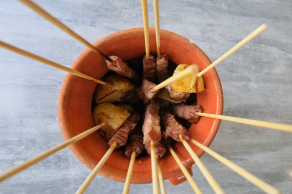 Arrosticini (skewers) are served in a terracotta container at Abruzzo Lab in Epping.