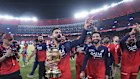 Royal Challengers Bengaluru's Virat Kohli celebrates with the trophy.