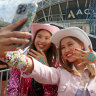 Taylor Swift fans snap a selfie outside Accor Stadium.
