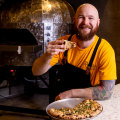 Ribelle chef-owner Dale Mann with a mustard tarragon chicken pie pizza from Ribelle, Freshwater.