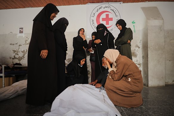 Mourners gather around the bodies of Palestinians, killed by Israeli fire after crossing the ceasefire line according to the Hamas-run Civil Defense, as they brought to Al Ahli Hospital in Gaza City.