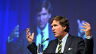 Tucker Carlson addresses a crowd, including federal MPs, at an event in Canberra on Tuesday.