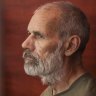 John Harding seen behind bars in a courtroom in Donetsk in August.