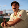 Pat Cummins poses with a replica Ashes urn after the final Test at the Oval.