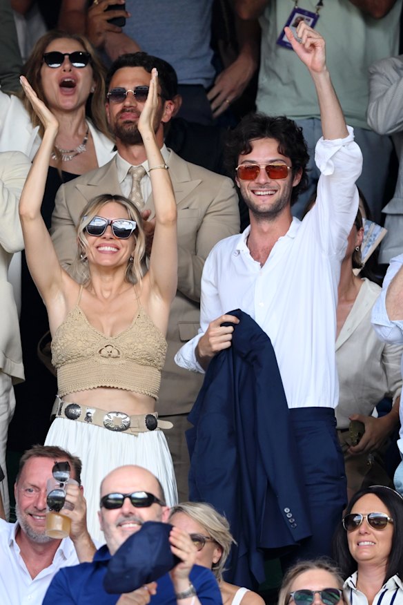Sienna Miller and boyfriend Oli Green celebrate on the final day of Wimbledon.