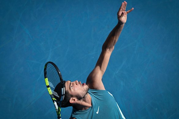 Alcaraz serves against Jack Draper of Great Britain.