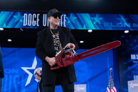 Elon Musk wields a chainsaw at a Conservative Political Action Conference in February.