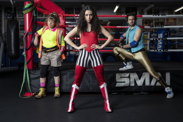 Genevieve Lemon (left), Zoe Ioannou and Aaron Tsindos jump in the ring for the new rock musical Dubbo Championship Wrestling at the Hayes Theatre.