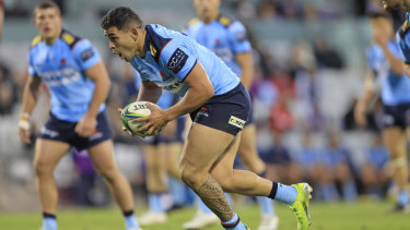 Izaia Perese runs the ball for the Waratahs against the Crusaders in Super Rugby Trans-Tasman this year. 