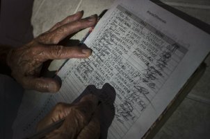 A man signs a petition against the interference of the United States in the internal politics of Venezuela. The 'Hands off Venezuela' campaign is organised by the government.