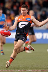 Toby Greene gets the ball away for the Giants.