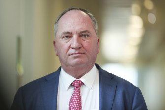 A man has been charged with threatening a police officer travelling with Deputy Prime Minister Barnaby Joyce on the federal election campaign.